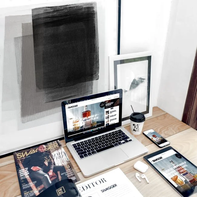 our-story Dual monitors on a desk, showcasing web design in a modern office setting.